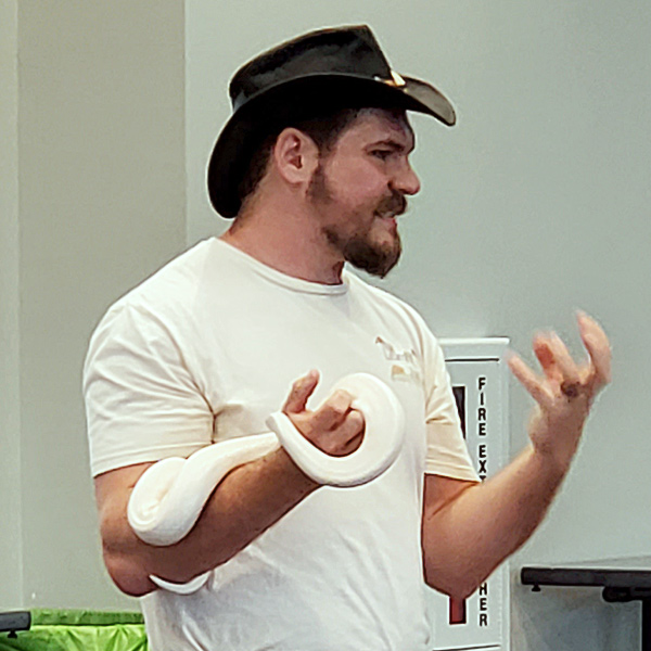 Learning Zoo presenter holding a white snake.